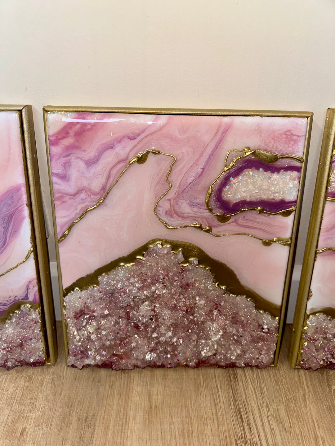 Pink and gold resin geode triptych with crushed crystal texture and gold framing.